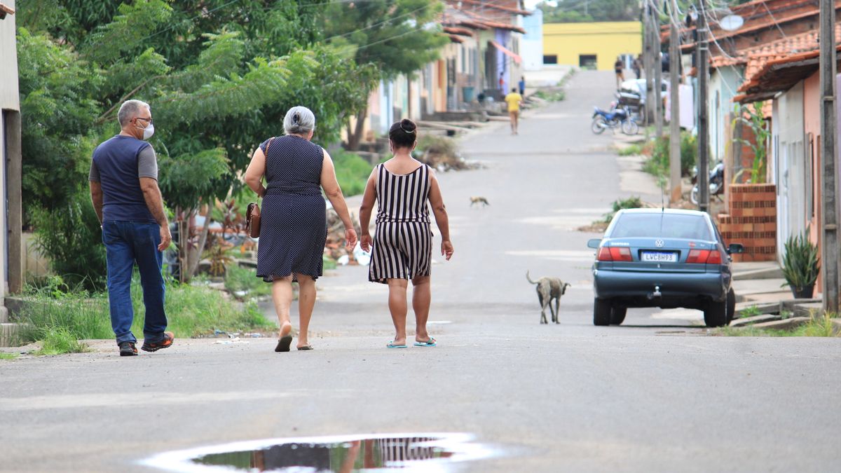 Neighbours walking together down a quiet small-town street