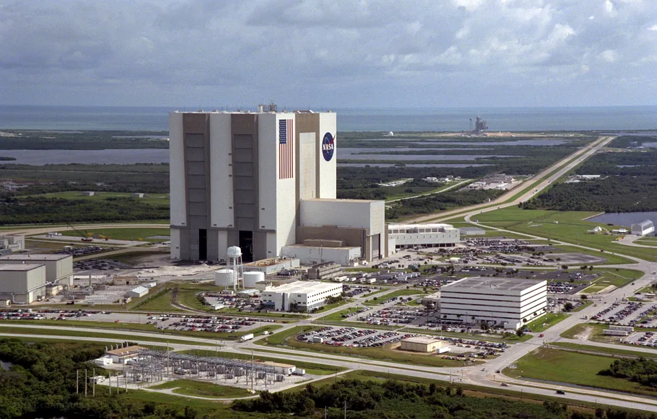 Aerial view of Kennedy Space Center's Launch Complex 39 area with the Vehicle Assembly Building, the Launch Control Center and the crawlerway leading toward the coast