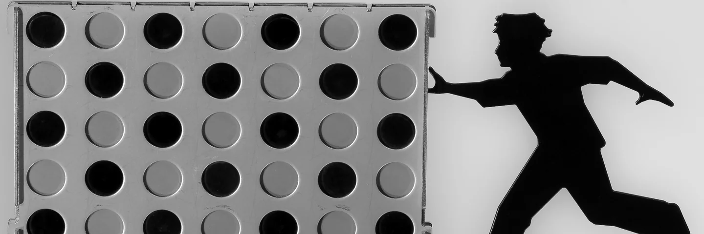 A four-in-a-row game frame with black and white discs