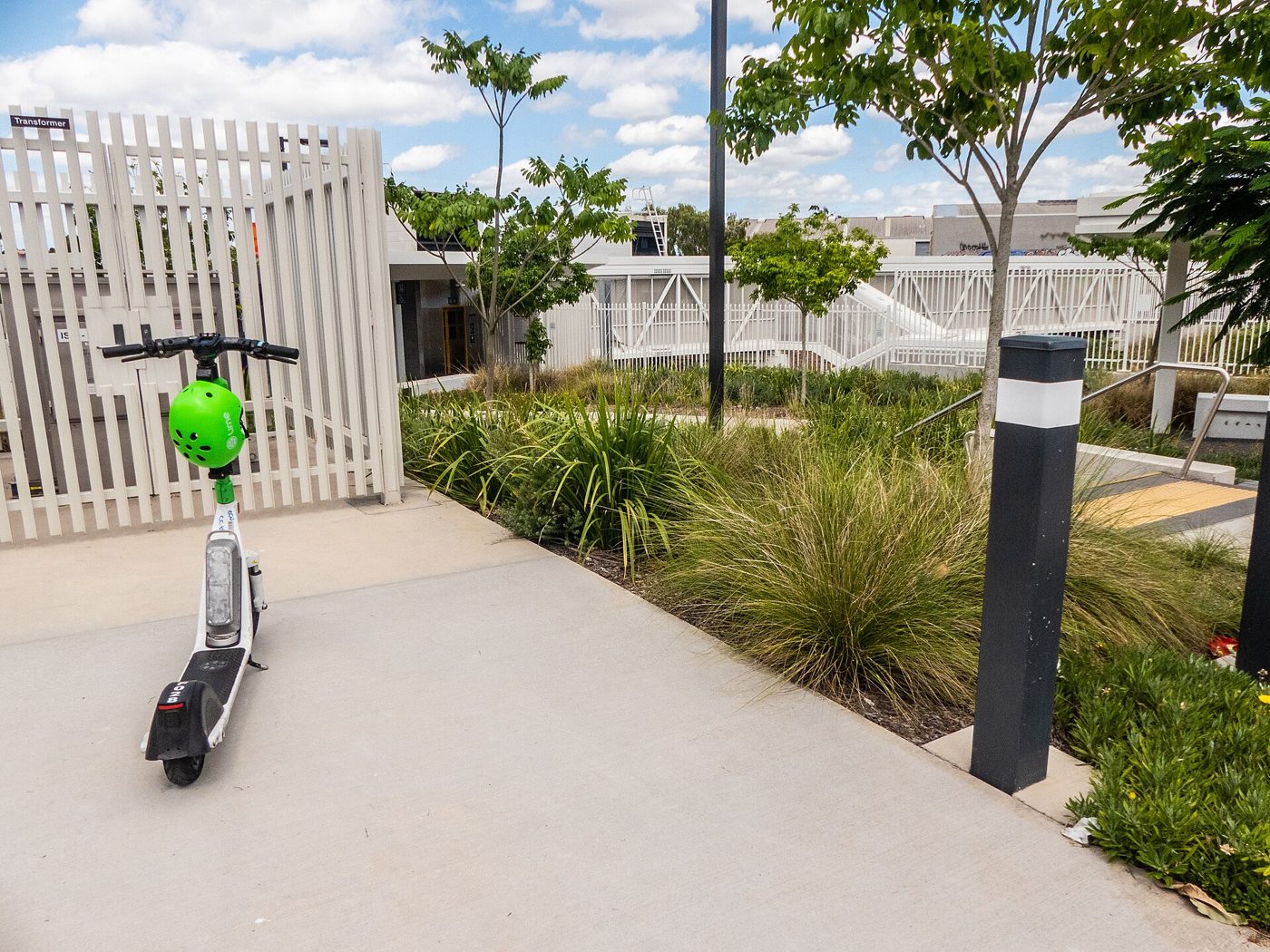 A Lime e-scooter parked at a station entrance (file photo, Australia)