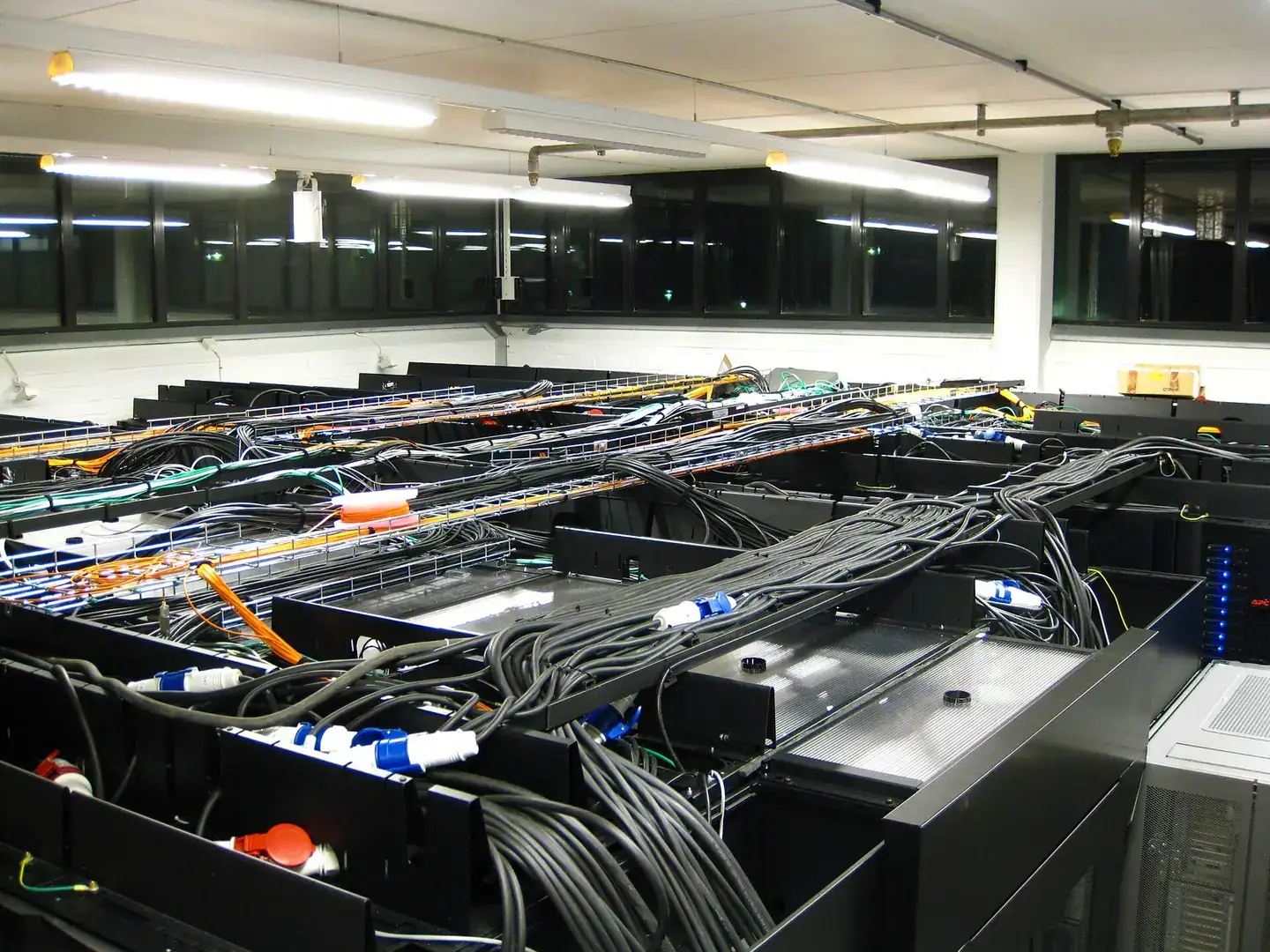 Server room at Royal Institute of Technology Parallel Computer Center.Thick black cables are power, orange and yellow