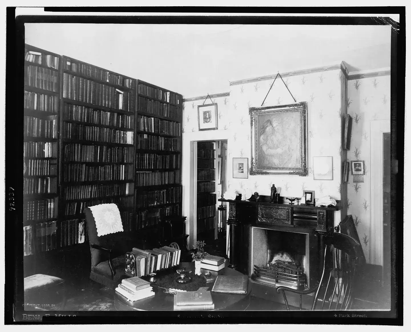 A historic study with bookshelves, a fireplace and a desk