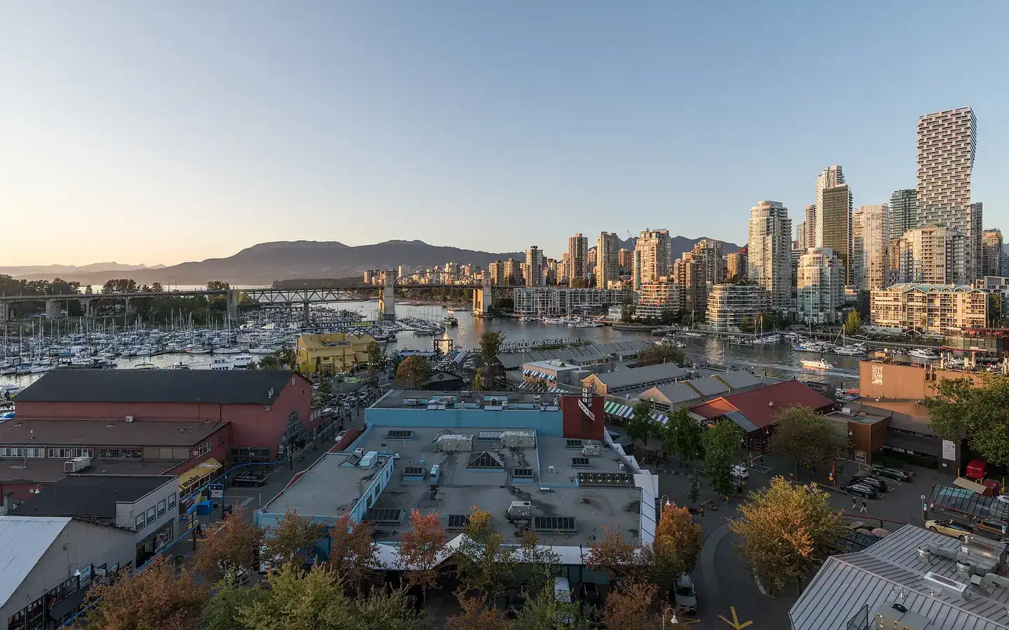 A view of Vancouver Skyline, Granville Island and Burrard St Bridge, as seen from Granville St Bridge at sunset