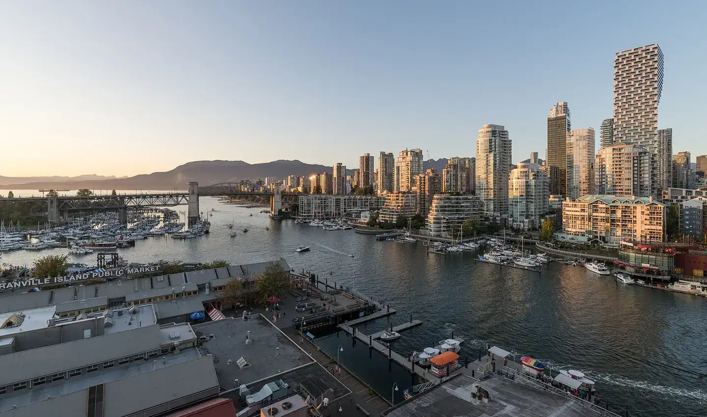 A view of Vancouver Skyline, Granville Island and Burrard St Bridge, as seen from Granville St Bridge at sunset