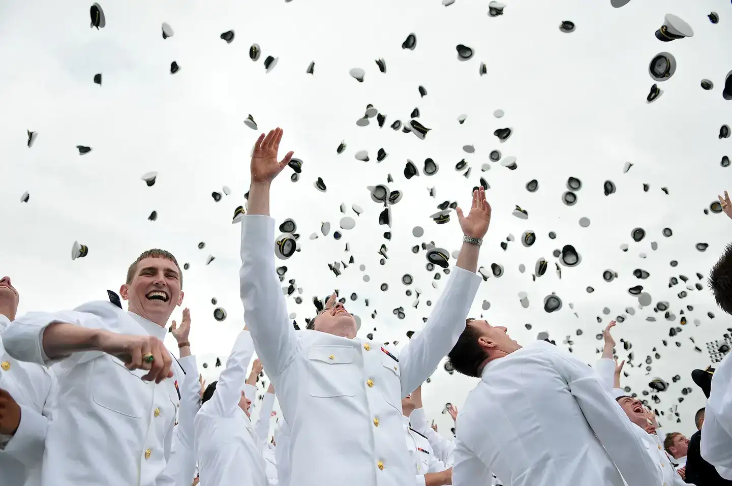 U.S. Naval Academy graduates toss their caps after the graduation and commissioning ceremony in Annapolis, Md., May 24