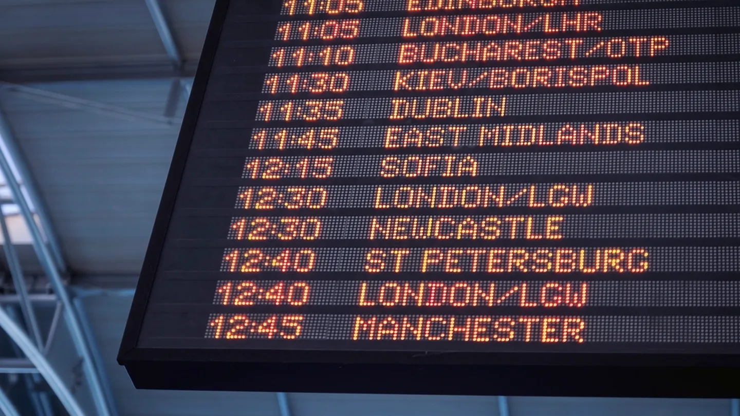 An airport departures board listing connecting flights