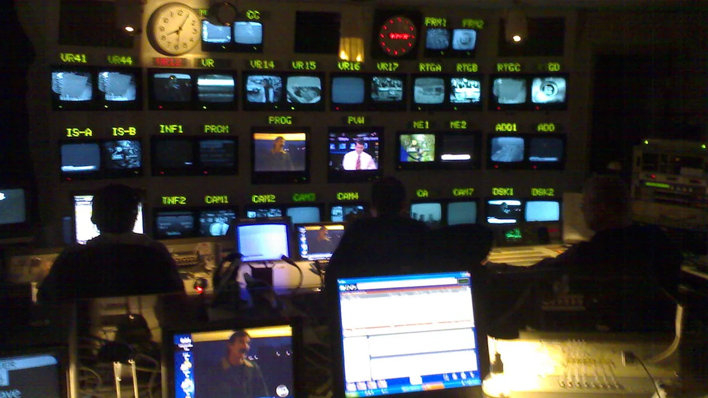 A control room wall of monitors and live dashboards