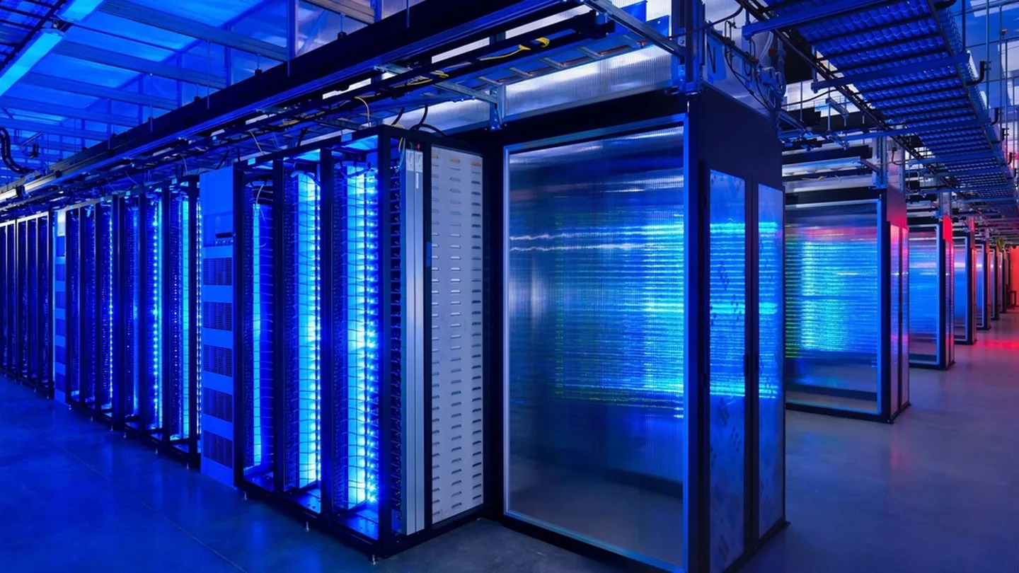 Rows of illuminated server racks in a data centre aisle