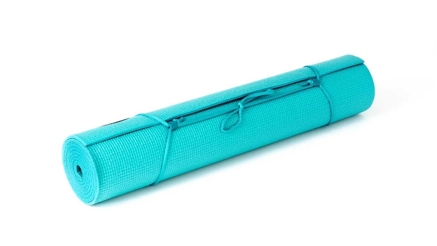 A turquoise exercise mat with carry strap for studio classes