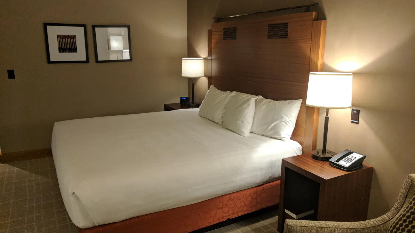 A quiet hotel room with warm bedside lamps
